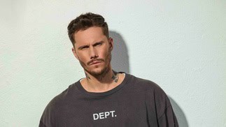 Modern man with tattoos wearing a dark sweatshirt on Partybody.